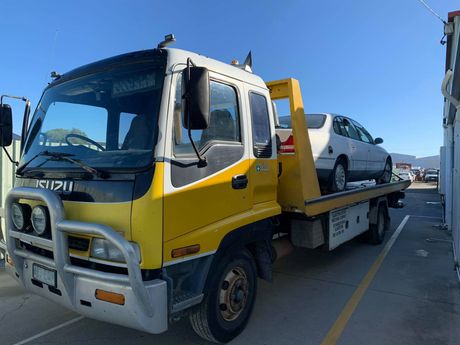 A White Car Is Being Towed by a Tow Truck | Gladstone, QLD | GMW Towing