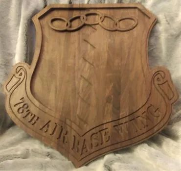 Wooden plaque featuring the emblem of the 78th Air Base Wing, with text and chain link design carved into the surface.