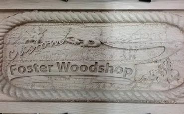 A wood-carved sign reads