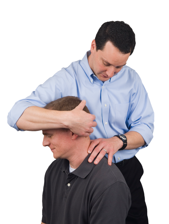 A man in a blue shirt is examining another man's neck