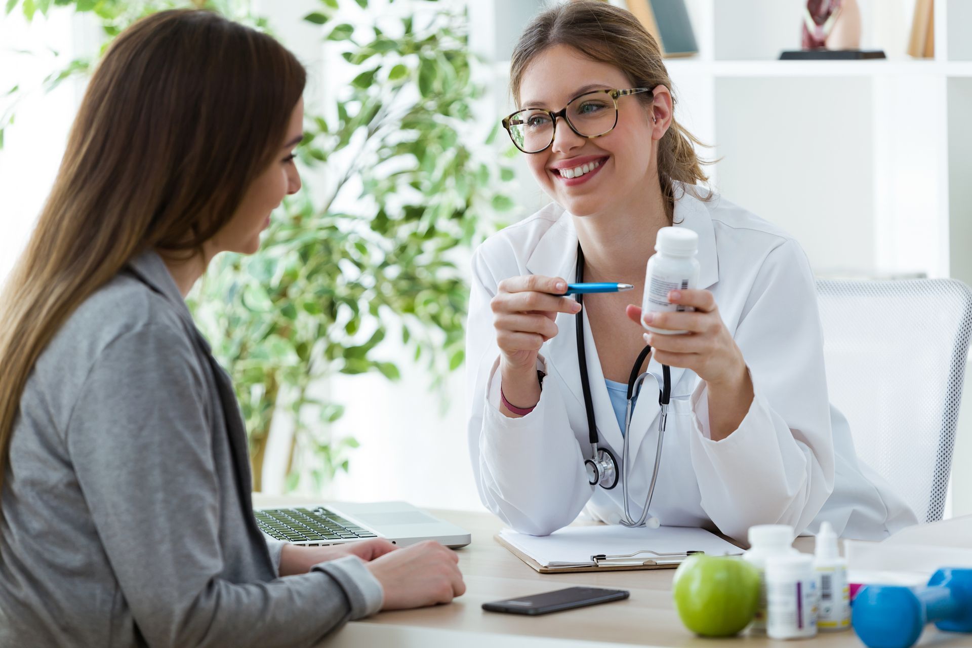 A woman is showing patient nutritional supplements.