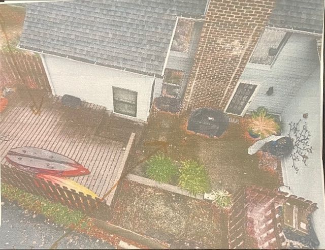An aerial view of a house with a kayak on the deck.