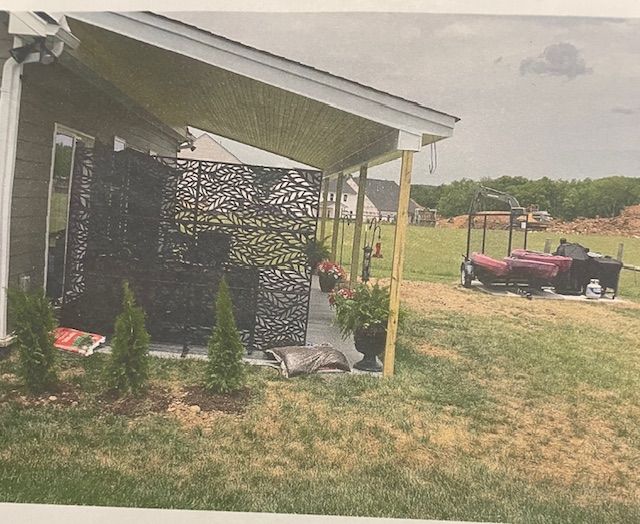 A picture of a house with a porch and lawn