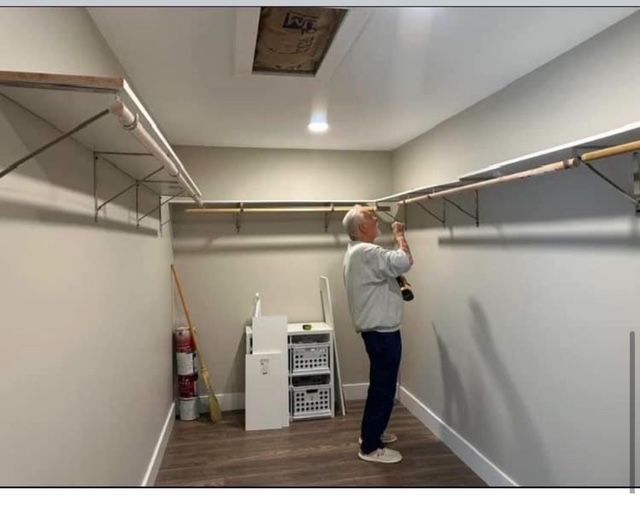 A man is working in a walk in closet