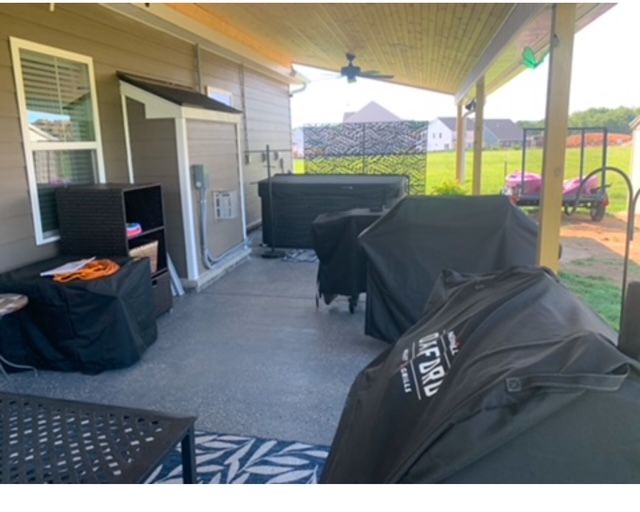 A covered porch with a grill that says lifetime on it