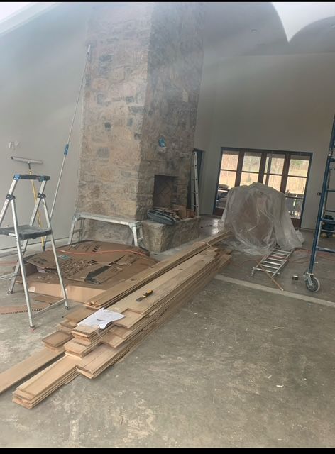 A room with a fireplace and a ladder in it