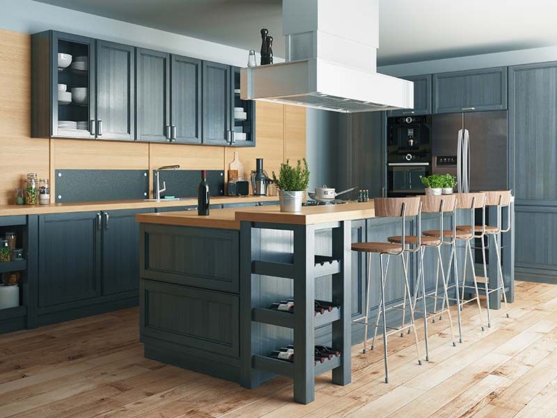 A modern kitchen with a large island and stools.