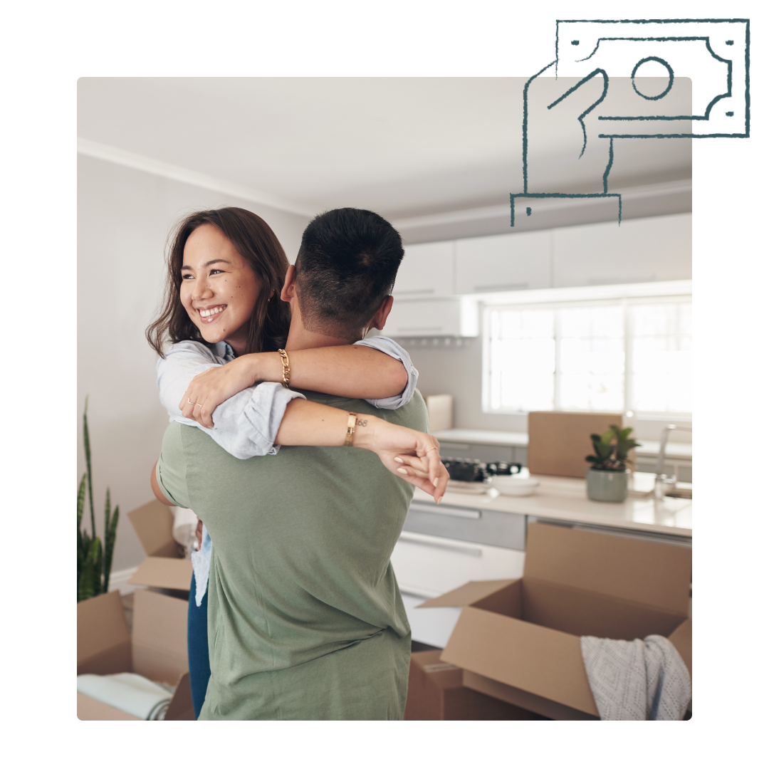Couple hugging in new home with moving boxes.
