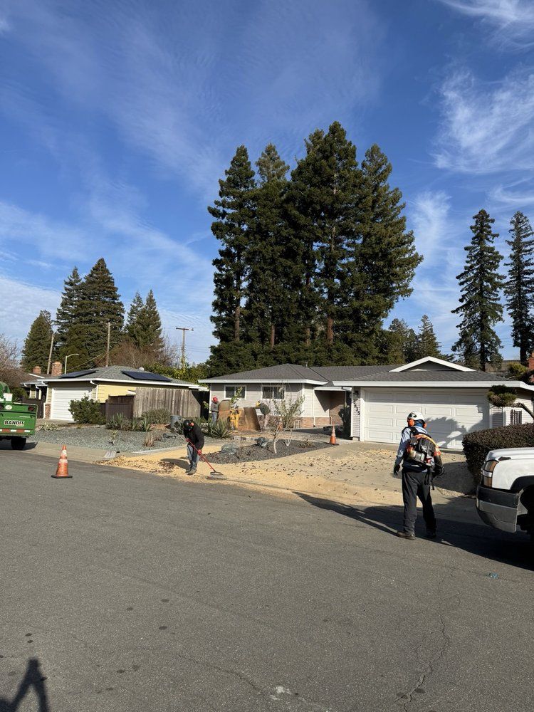 A couple of men are standing in front of a house.
