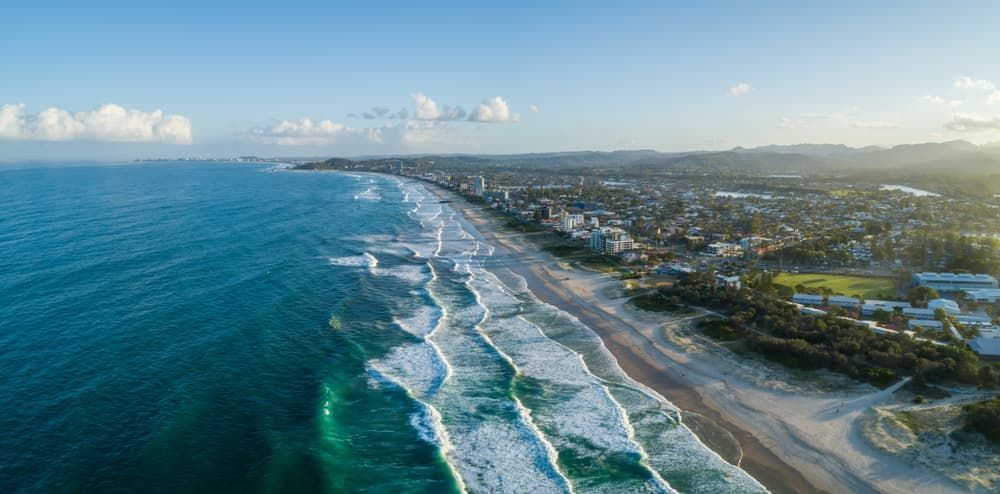 Aerial View of a Beach With Waves Crashing on the Shore — Gold Coast Roof Repairs in Palm Beach, QLD