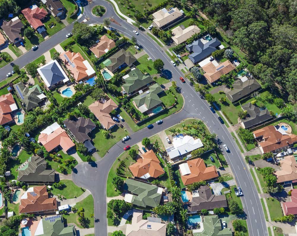 An Aerial View Of A Residential Area With Lots Of Houses And Trees — Gold Coast Roof Repairs in Ormeau, QLD