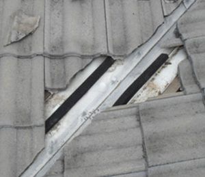 Installing Valley Seal On A Grey Tiled Roof — Gold Coast Roof Repairs in Mudgeeraba, QLD