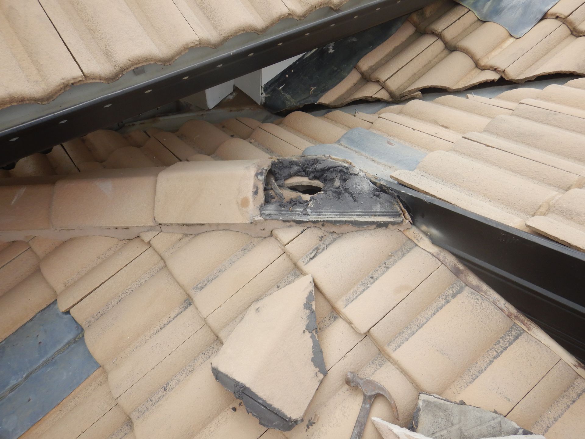 A Close Up Of A Roof With A Damaged Tile — Gold Coast Roof Repairs in Mudgeeraba, QLD