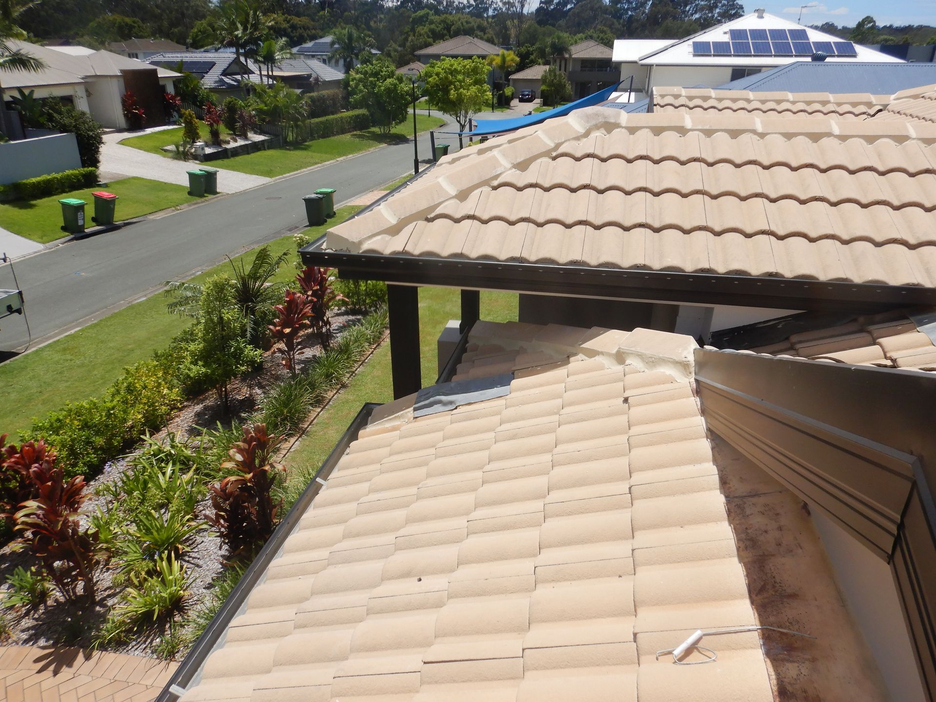 A Construction Worker Is Working On The Roof Of A Building — Gold Coast Roof Repairs in Mudgeeraba, QLD