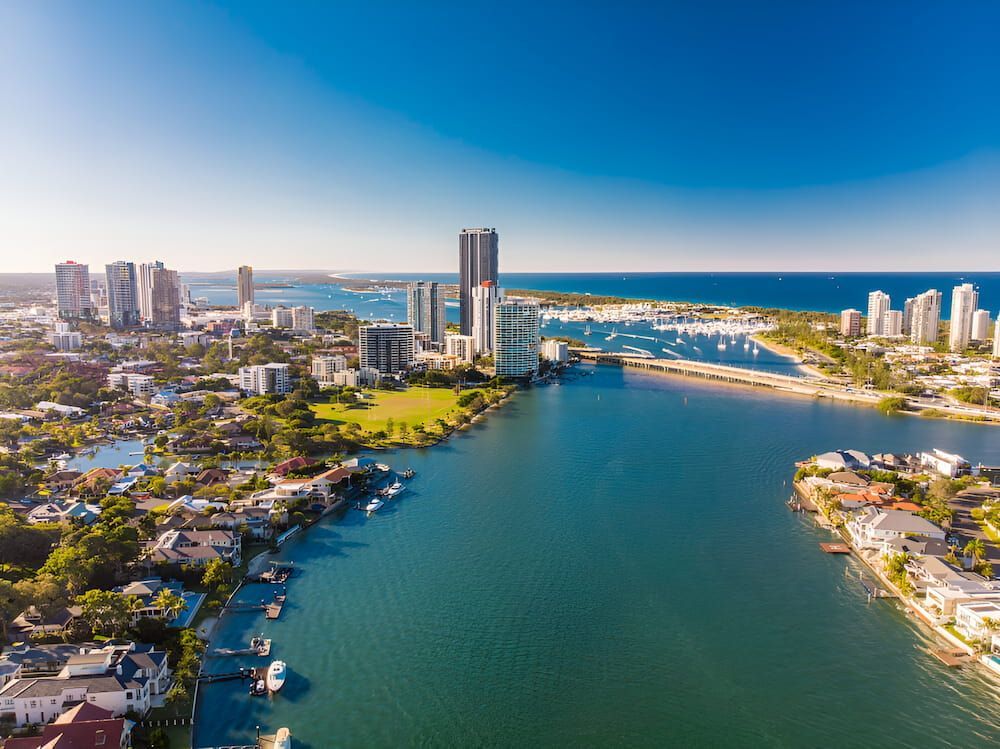 An Aerial View Of A City Surrounded By Water And Buildings — Gold Coast Roof Repairs in Southport, QLD