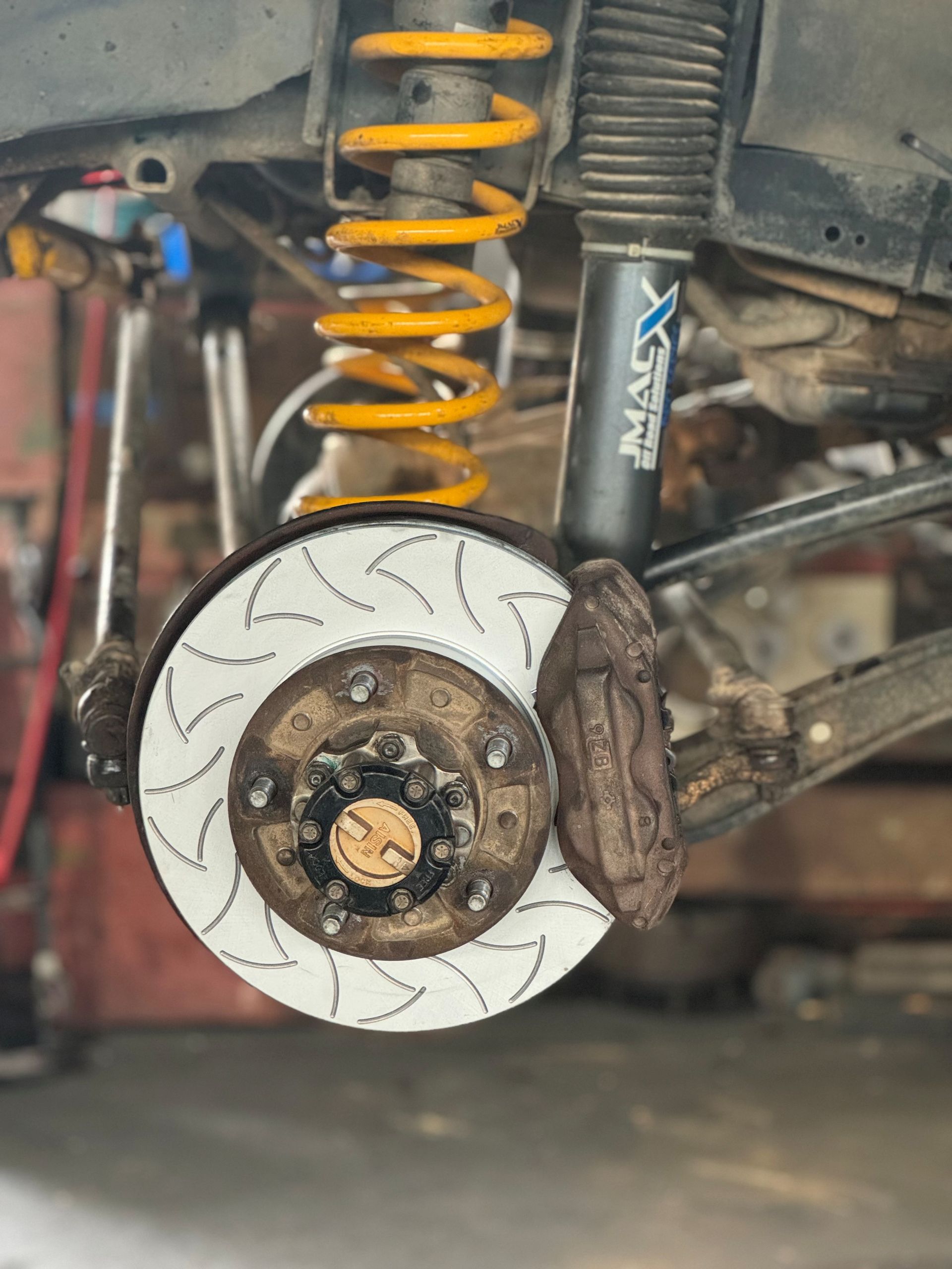 A Man Is Working On The Engine Of A Red Truck — SRG Automotive and Marine in Aitkenvale, QLD