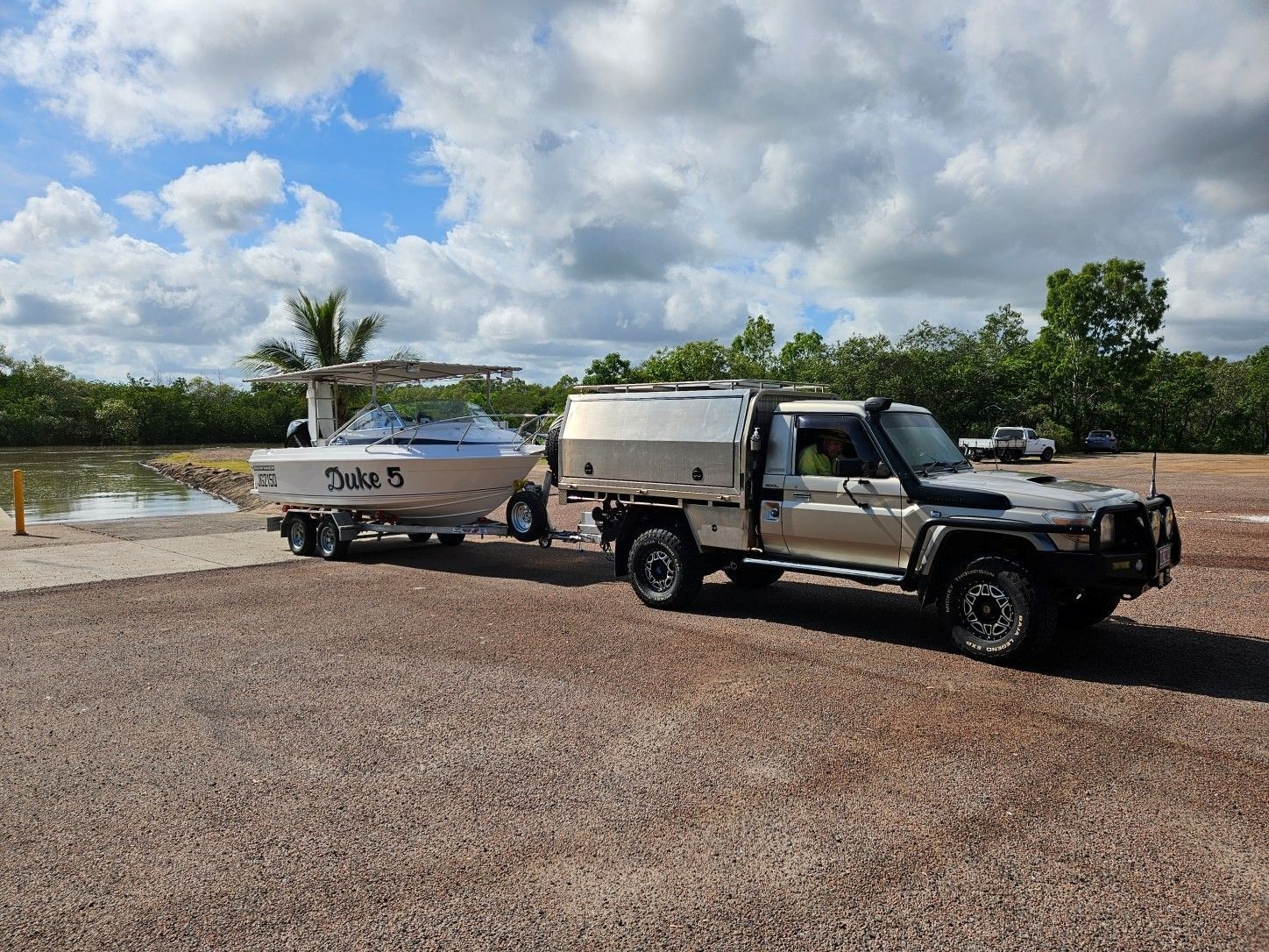 A Black Truck Is Parked On A Dirt Road Near The Ocean — SRG Automotive and Marine in Aitkenvale, QLD