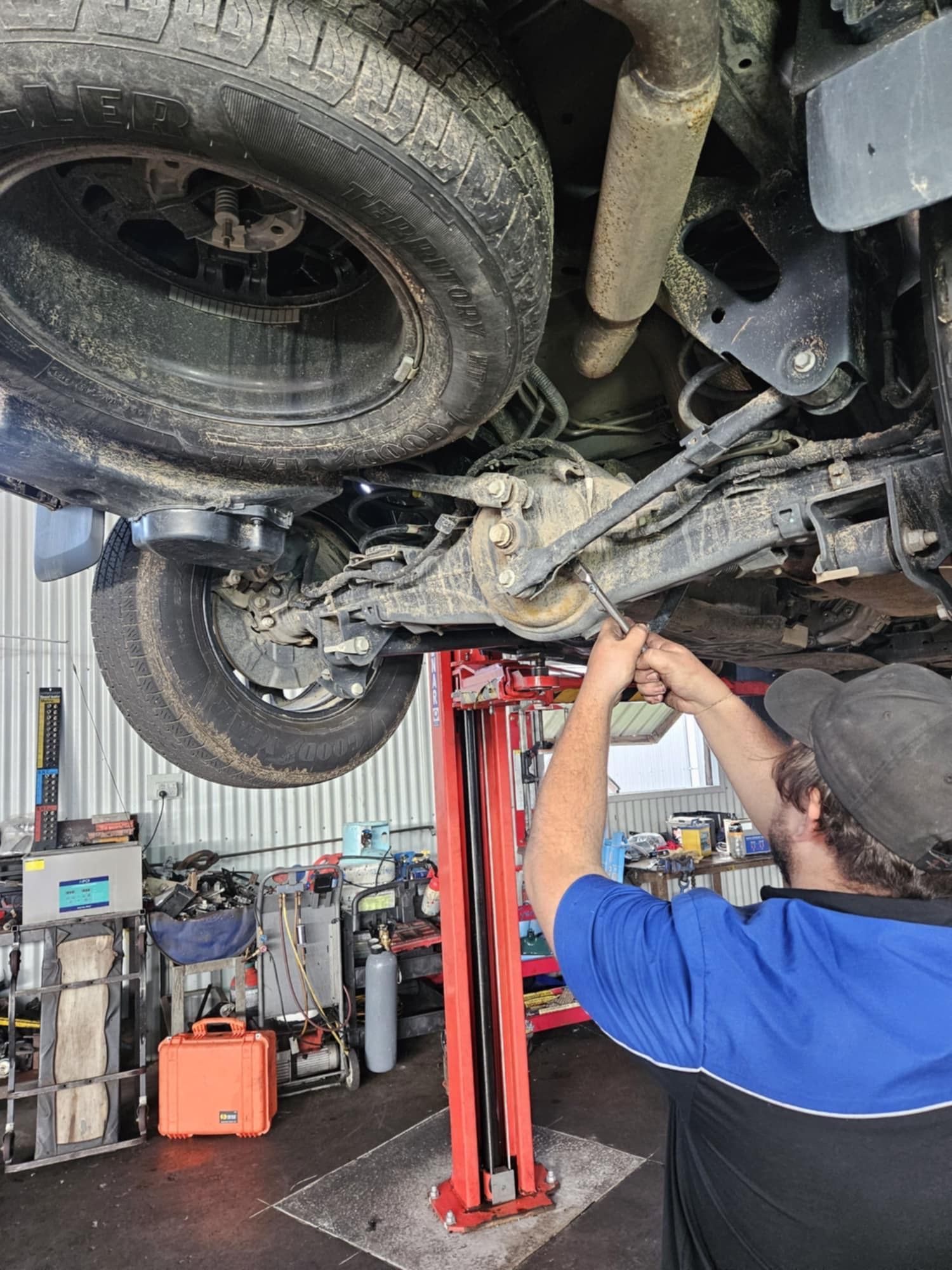 A Person Is Working On The Engine Of A Car — SRG Automotive and Marine in Aitkenvale, QLD