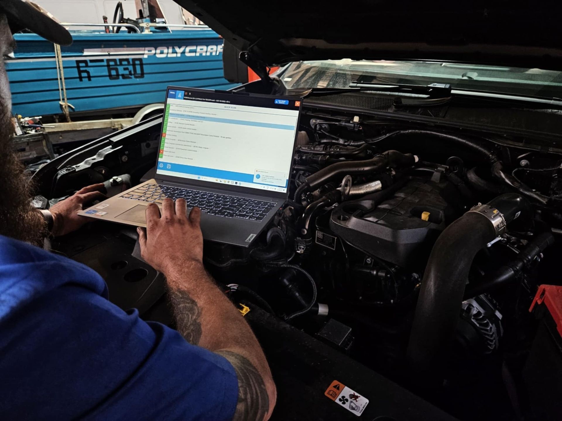 A Man Is Driving A Car And Pressing A Button On The Dashboard — SRG Automotive and Marine in Aitkenvale, QLD