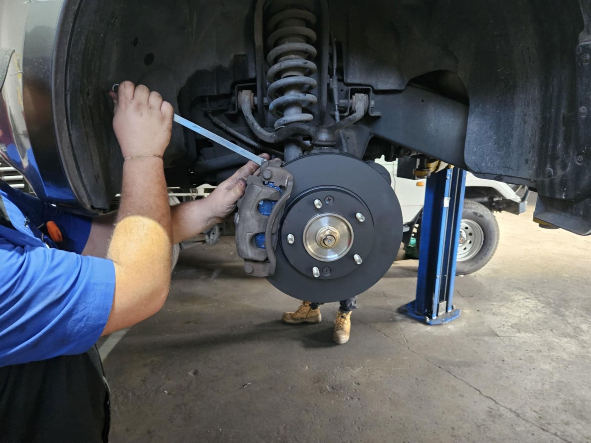 A Man Is Working On The Engine Of A Boat — SRG Automotive and Marine in Aitkenvale, QLD