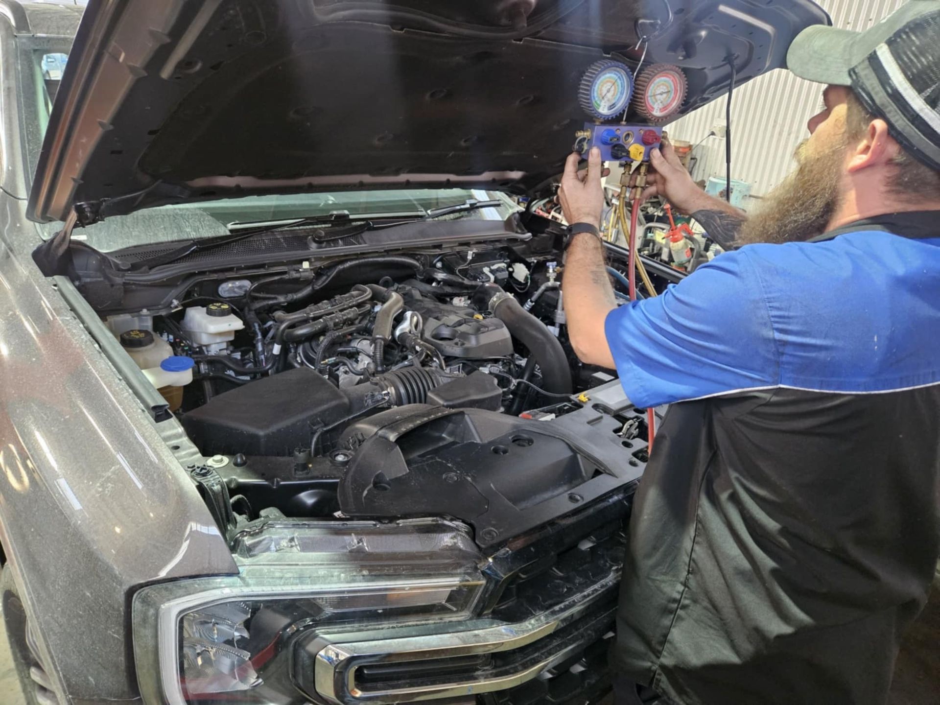 A Person Is Driving A Car With Their Hands On The Steering Wheel — SRG Automotive and Marine in Aitkenvale, QLD