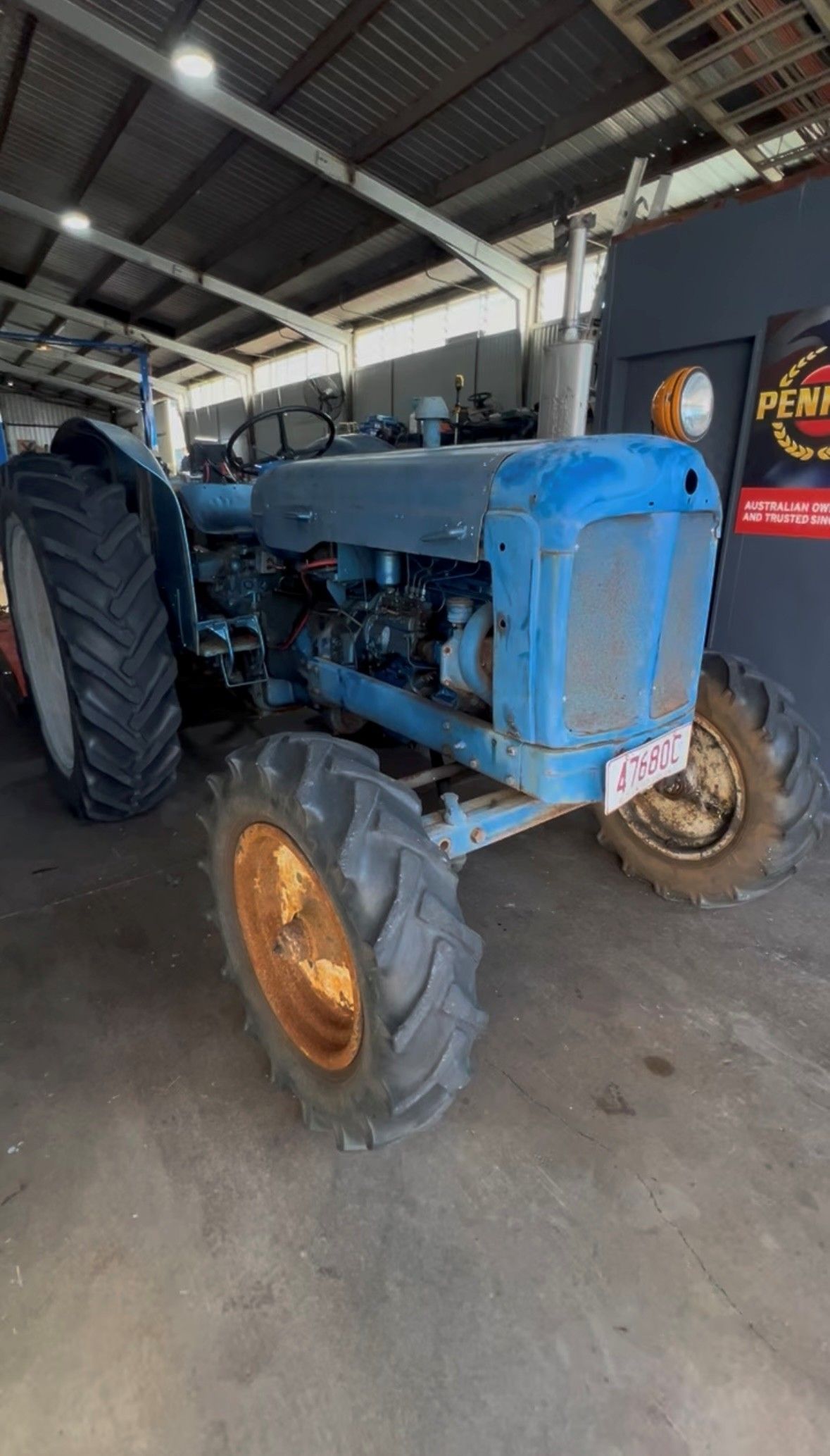 A Man Wearing A Welding Mask Is Working On A Car In A Garage — SRG Automotive and Marine in Aitkenvale, QLD