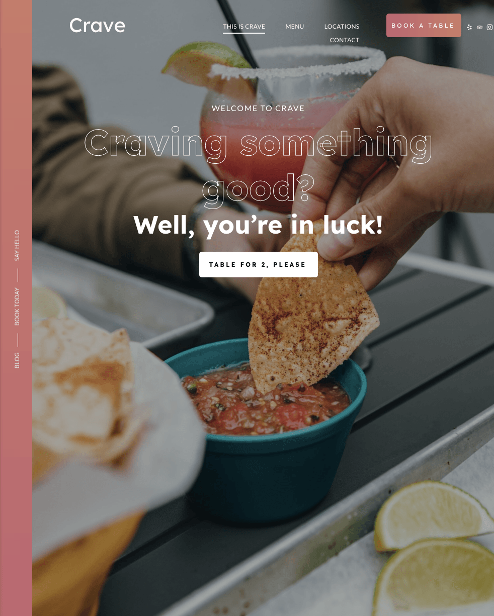 A person is dipping a tortilla chip into a bowl of salsa.