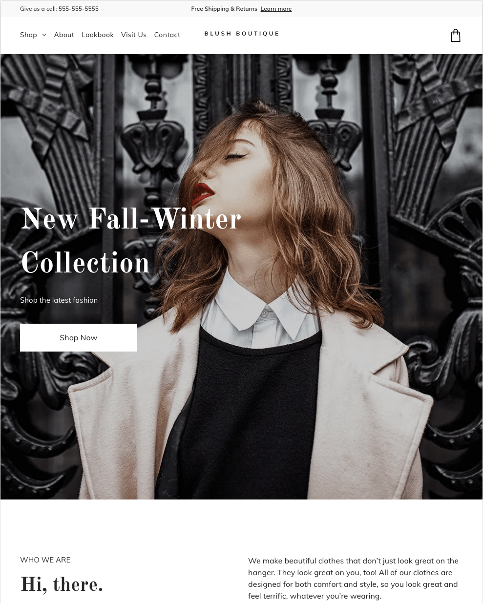 A woman in a coat is standing in front of a black wall.