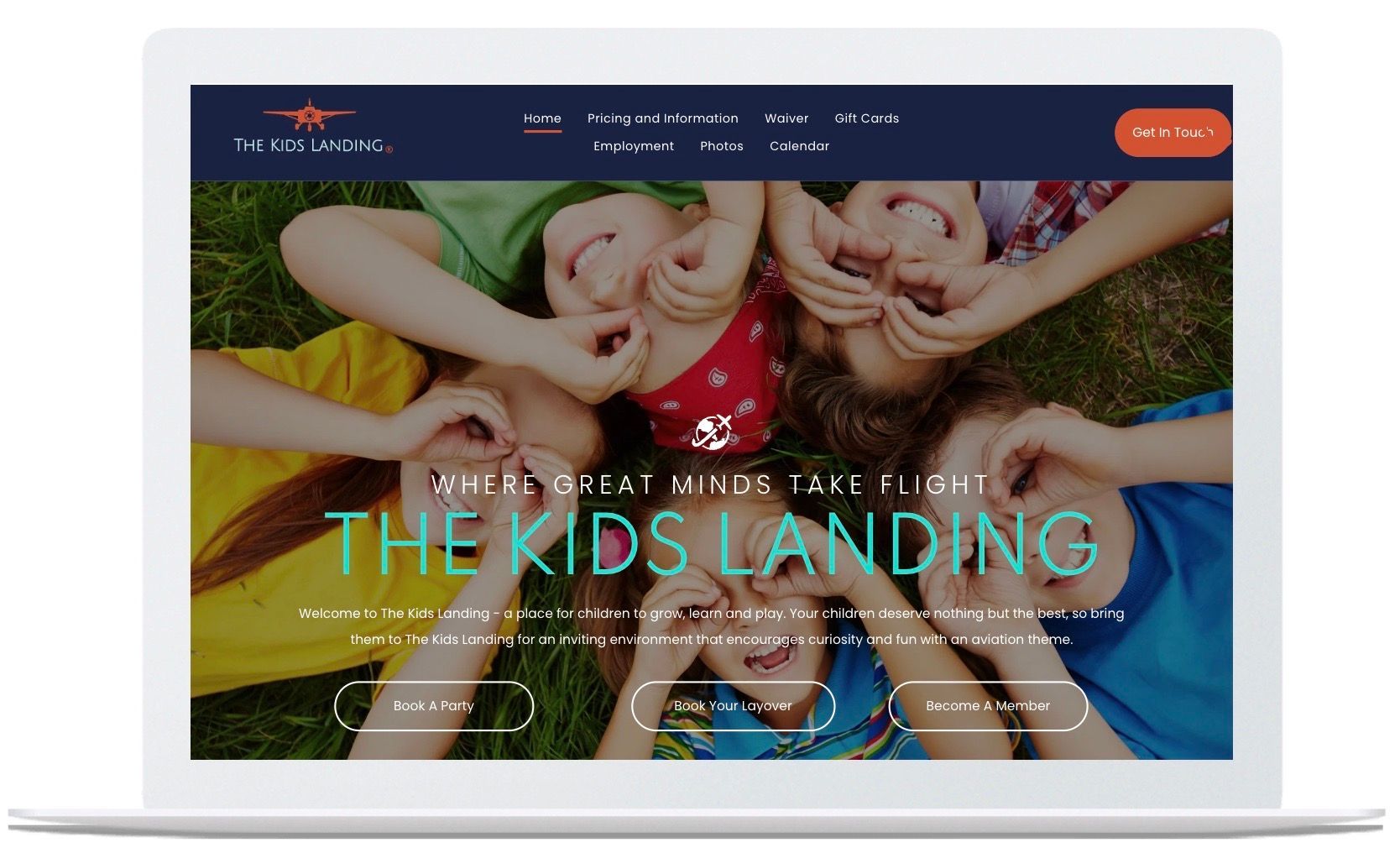 A laptop screen shows a website for the kids landing.
