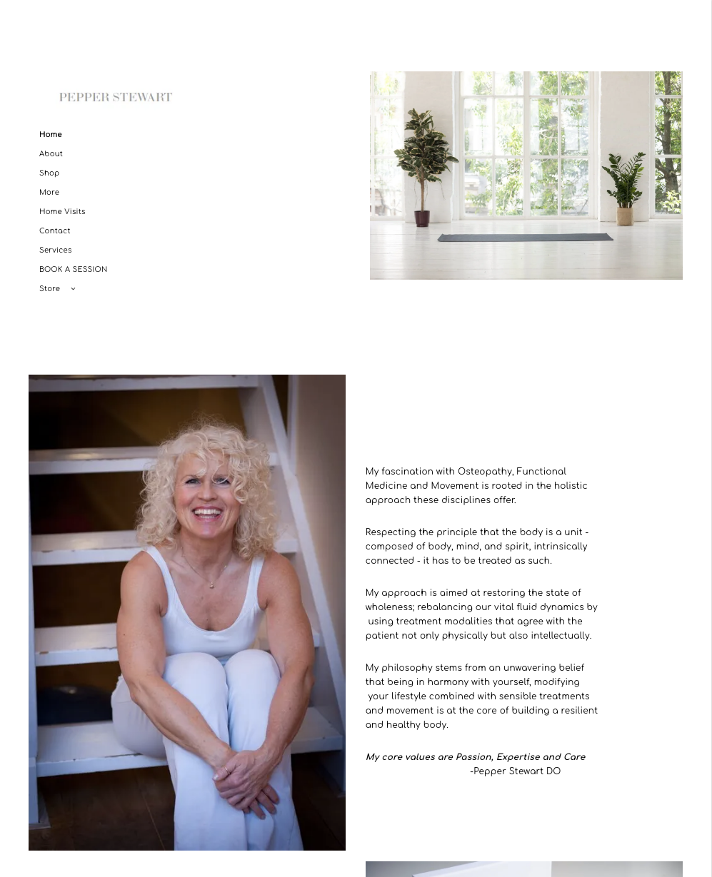 A woman is sitting on a set of stairs and smiling.