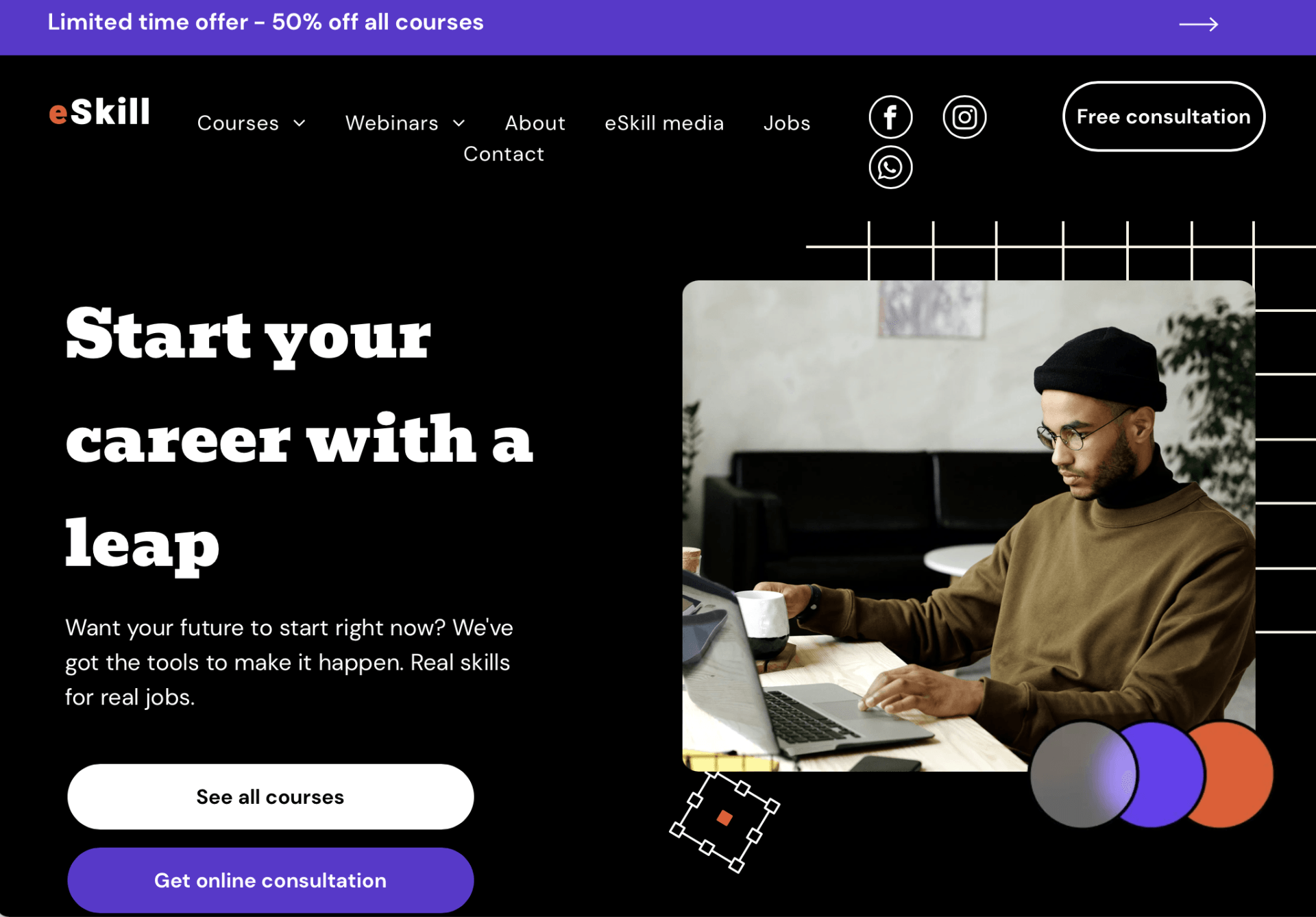 A man is sitting at a desk using a laptop computer.