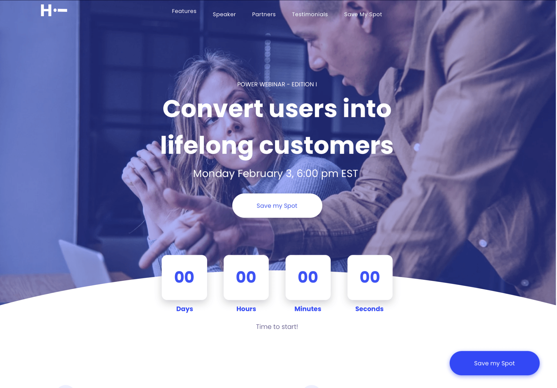 A man and a woman are looking at a laptop computer.