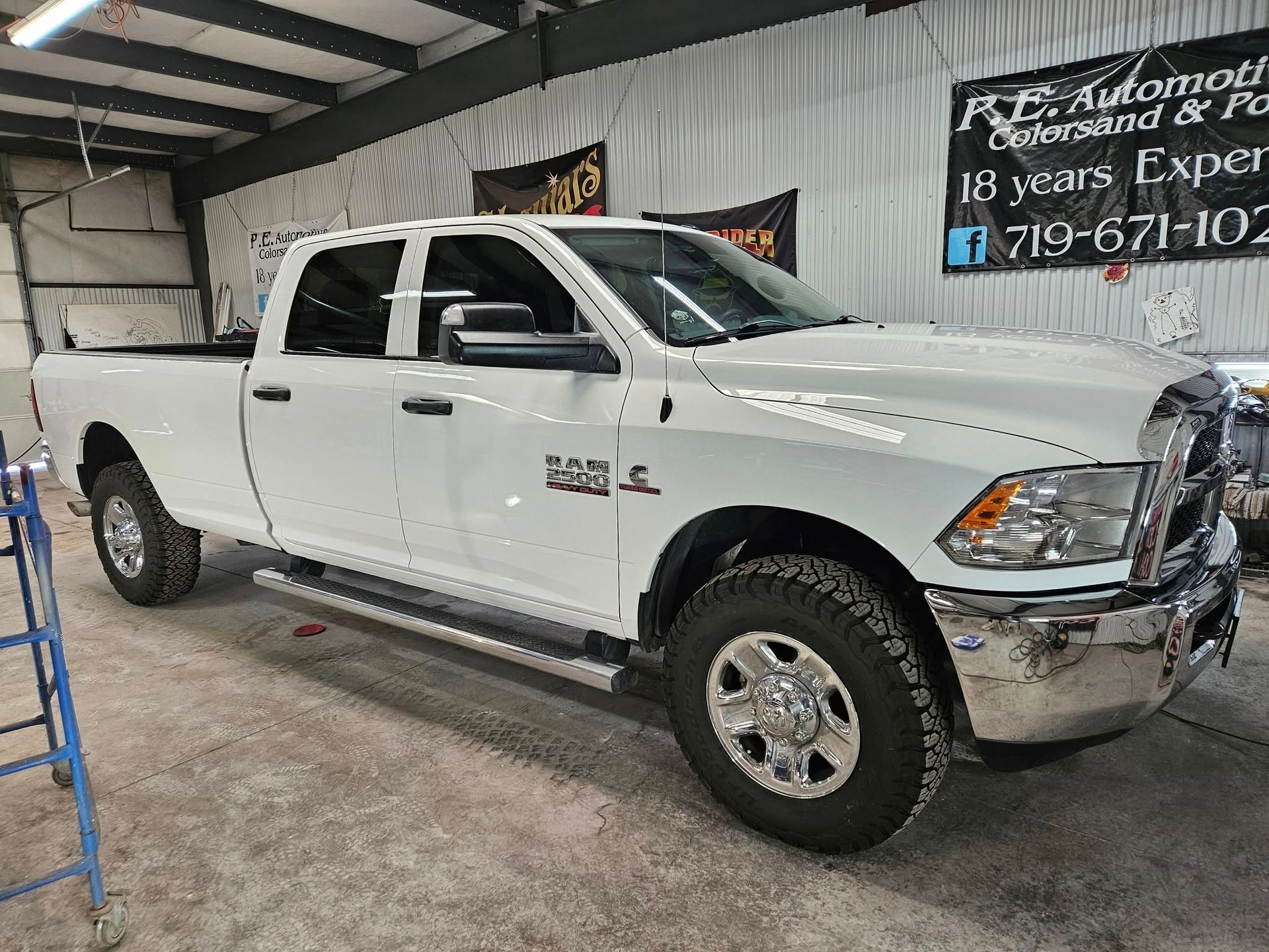 White Ram 2500 pickup truck parked inside a shop.