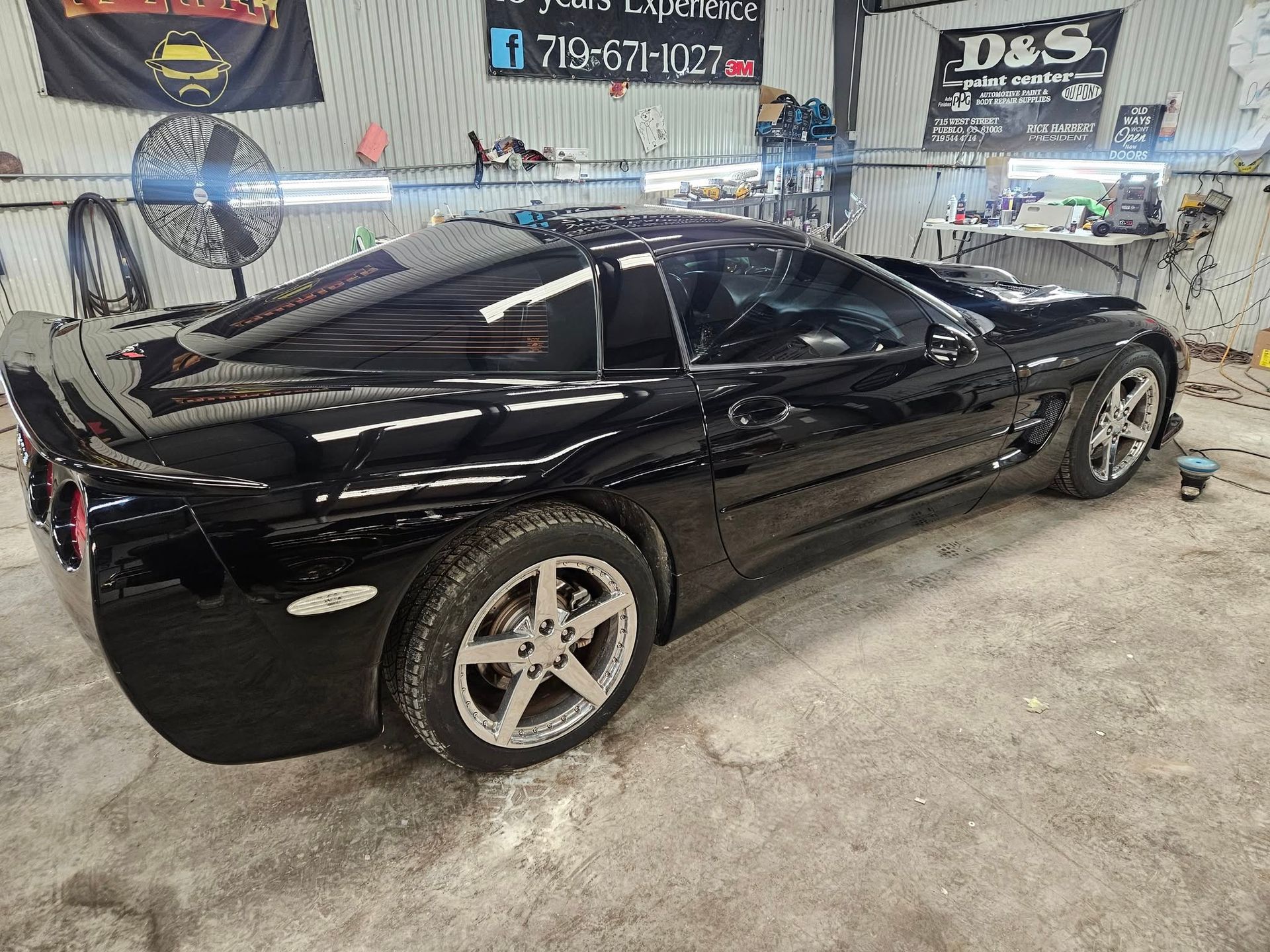 Black Corvette sports car inside a garage.
