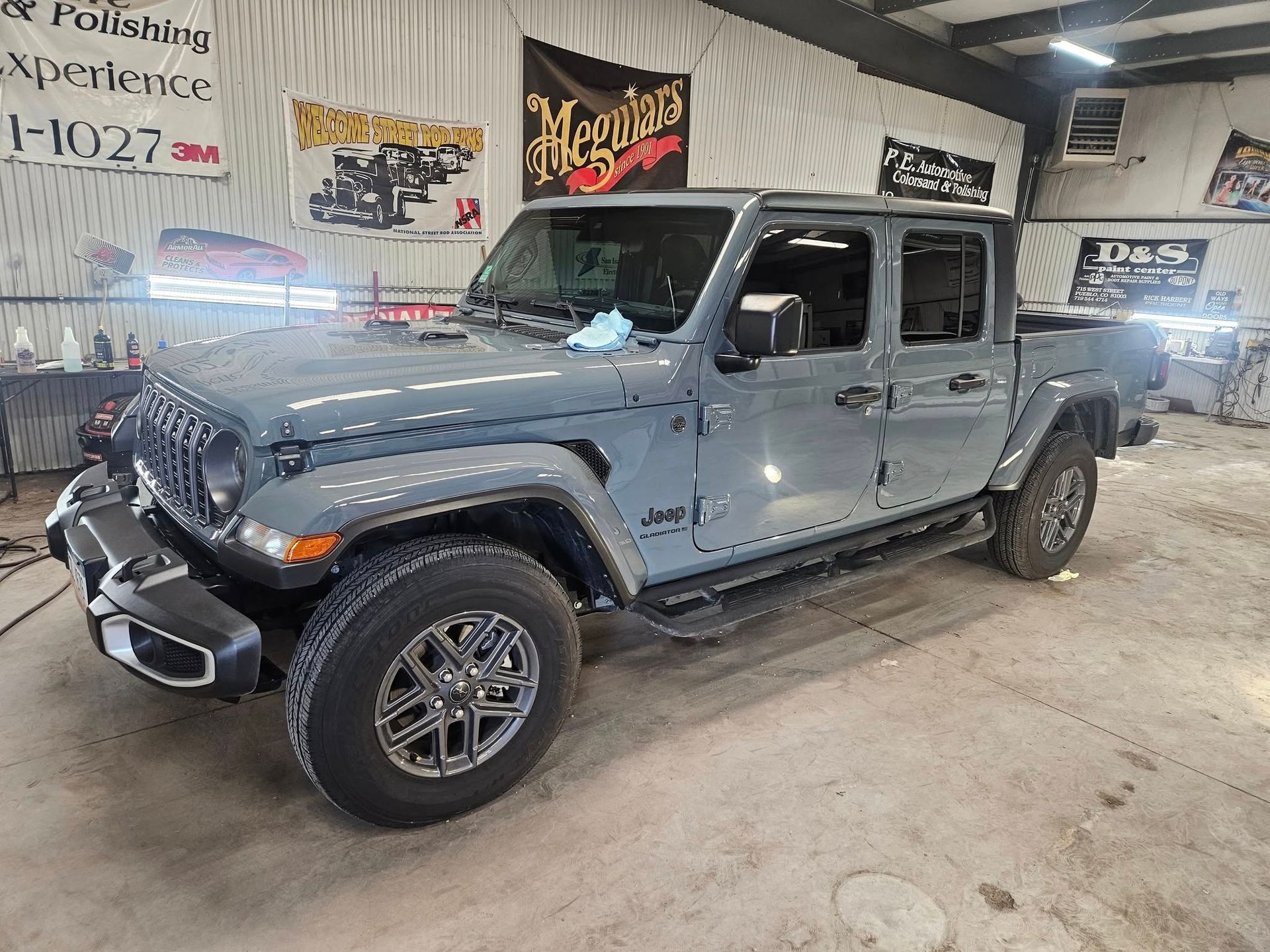 Gray Jeep Gladiator pickup truck inside a garage.
