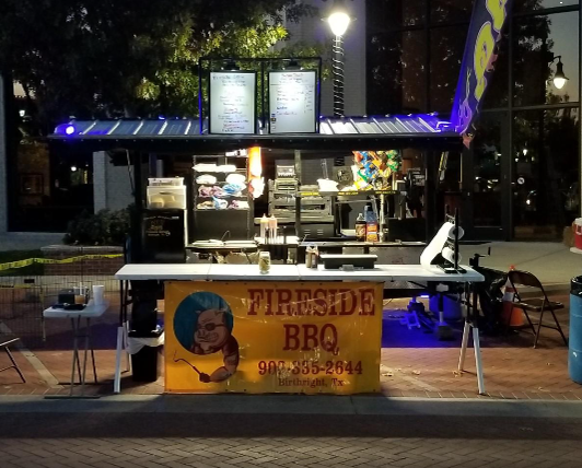 A yellow sign that says fireside bbq on it