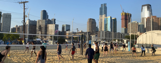 Baseball player sliding into home plate, catcher in front. Blue and gold uniforms, action shot.