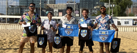 Baseball glove with ball on green grass, with blurred baseballs in the background.