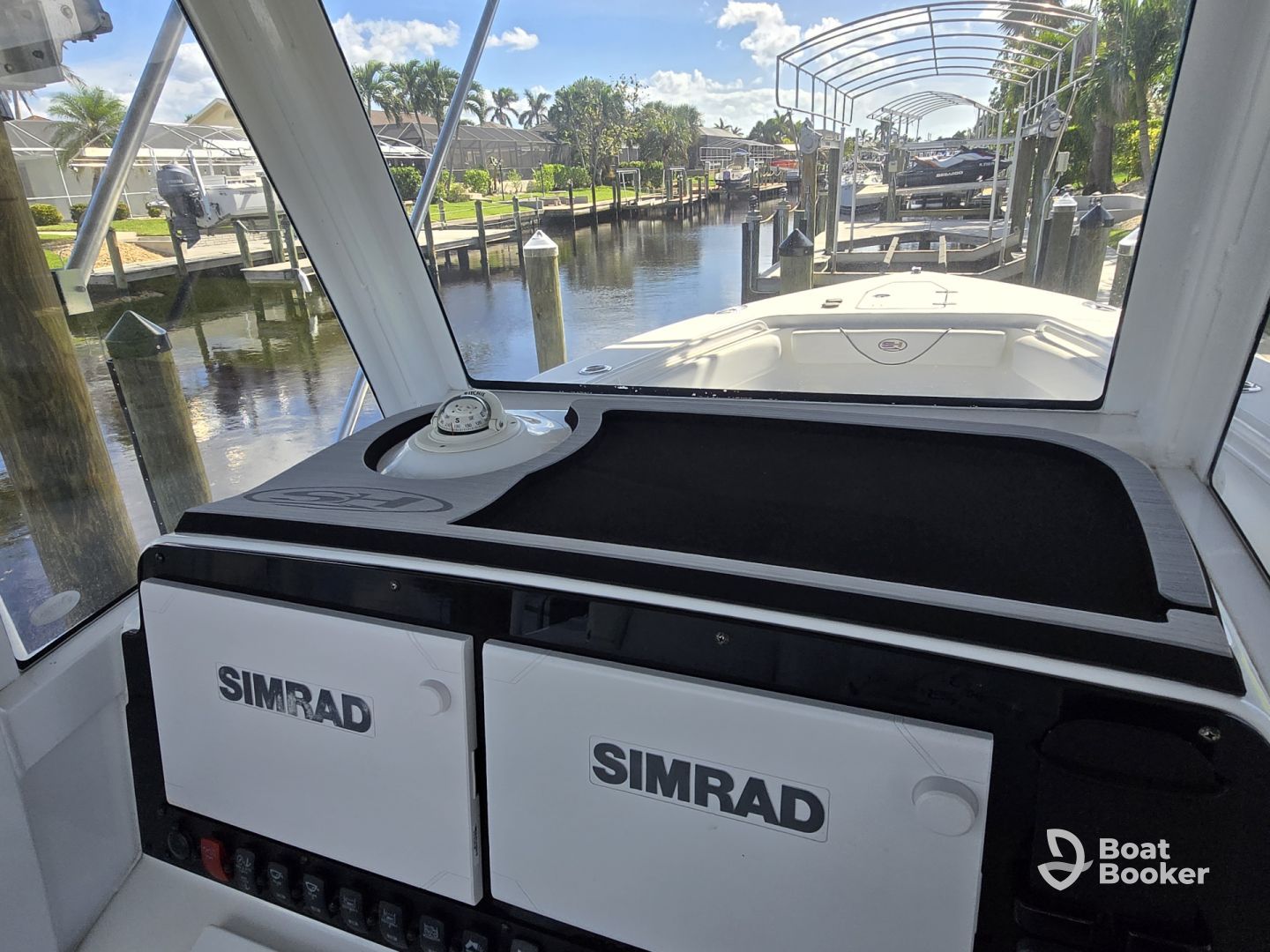 The inside of a pontoon boat with a gray and white seat