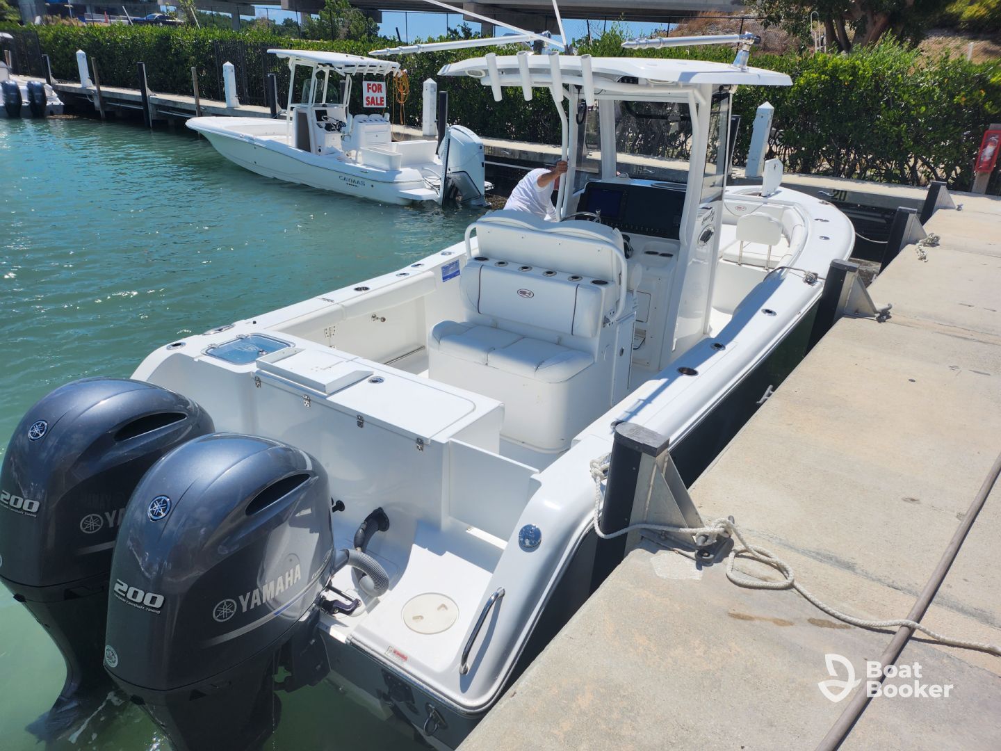 The inside of a pontoon boat with a gray and white seat