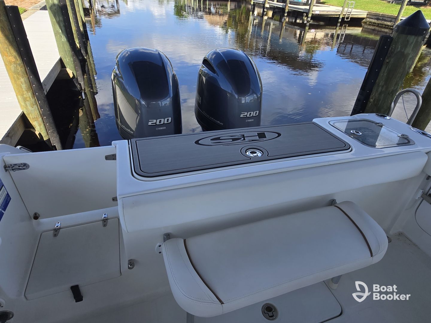 A woman is standing on a boat holding a dog.