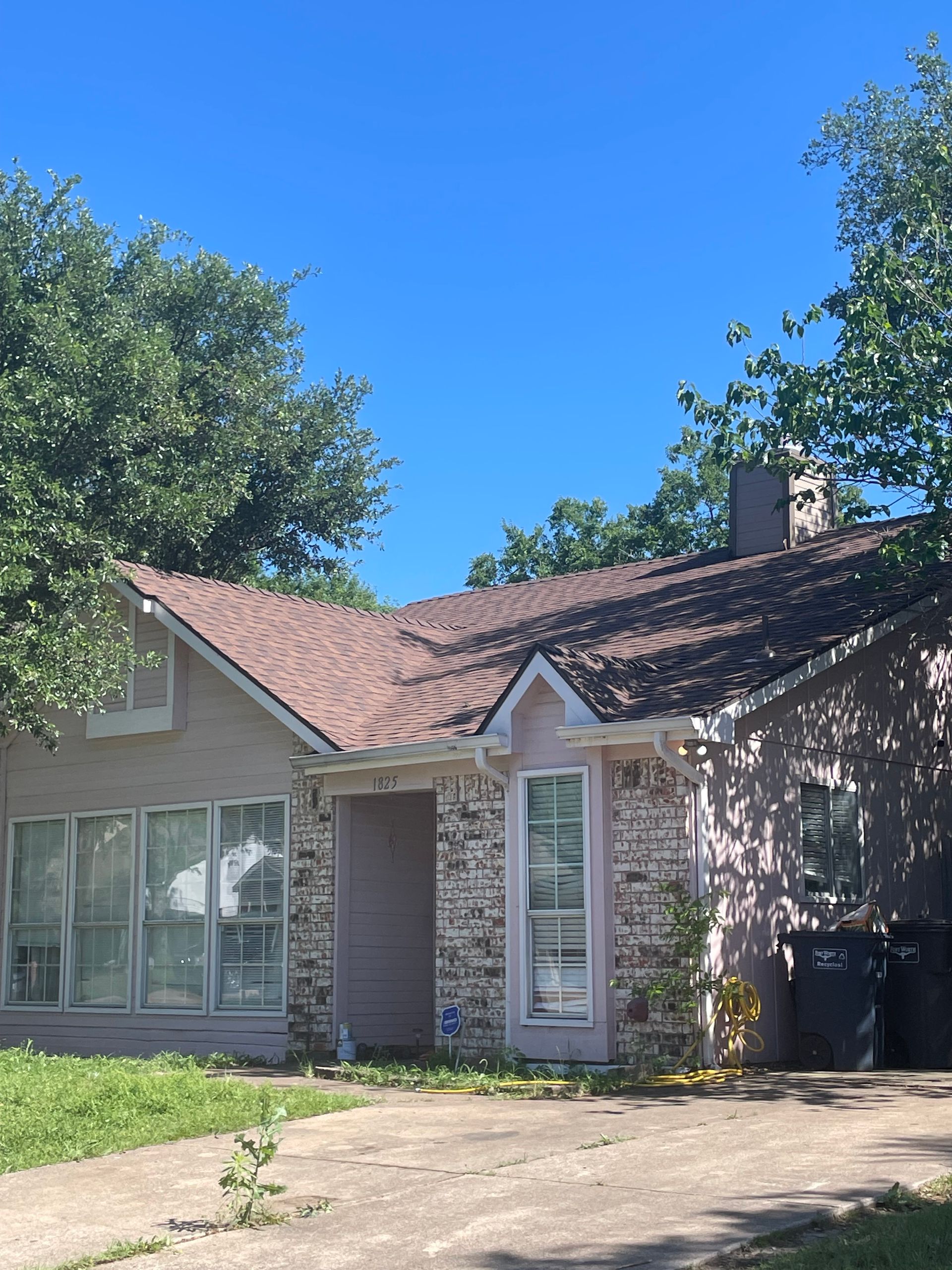 A house with a red roof and a lot of windows