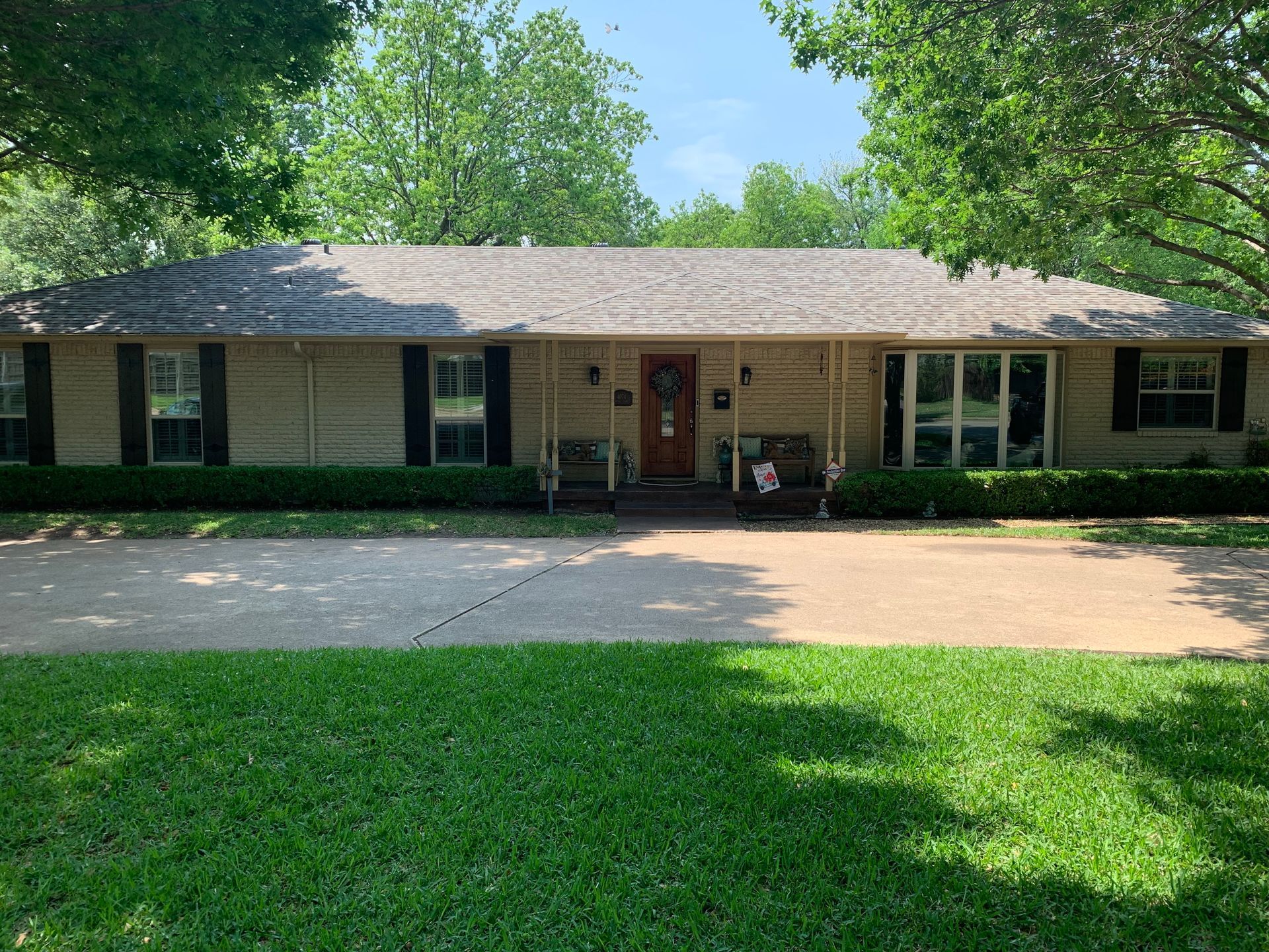 A large house with a porch and a lot of windows