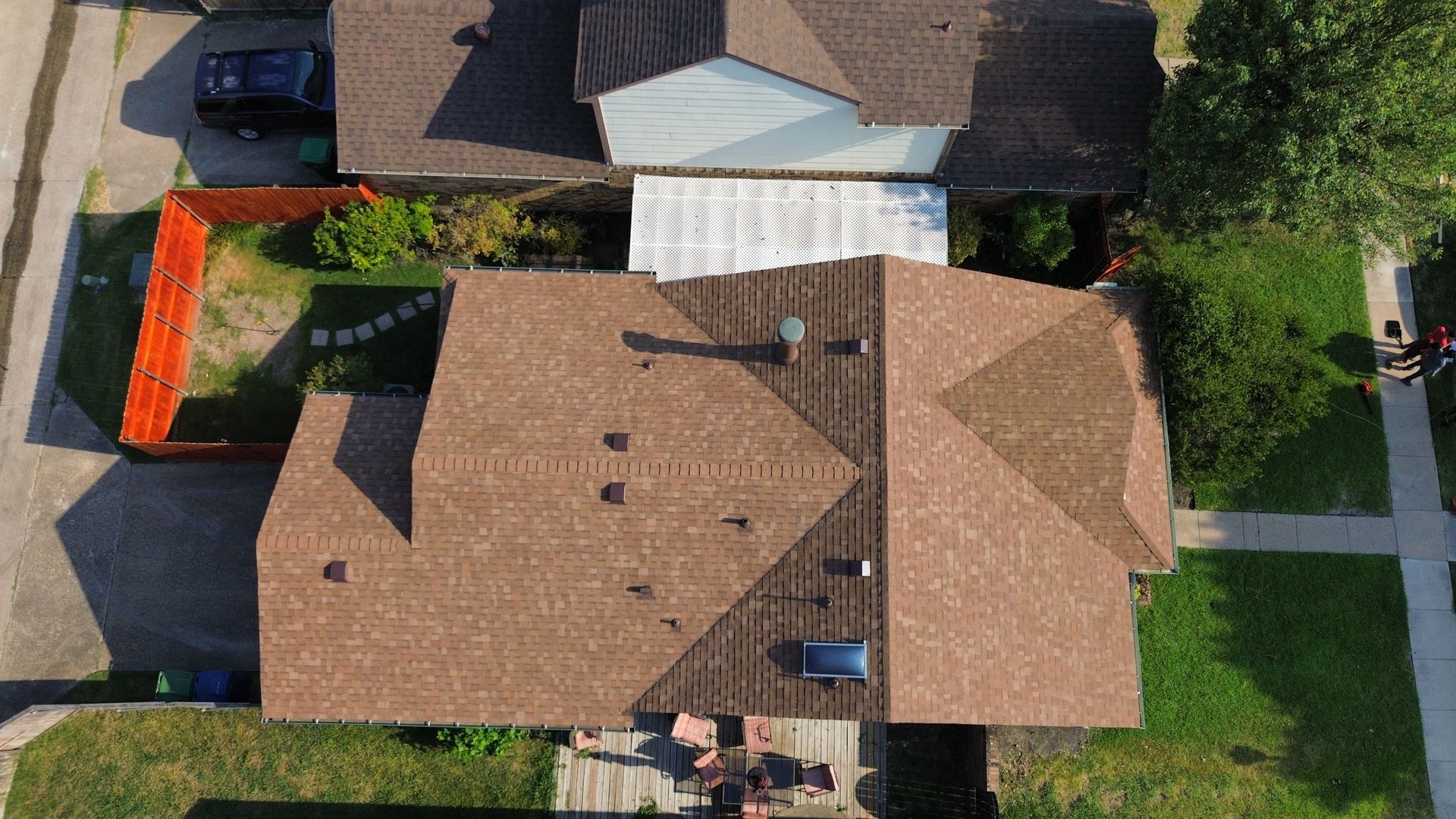 An aerial view of a house with a roof that is being repaired.