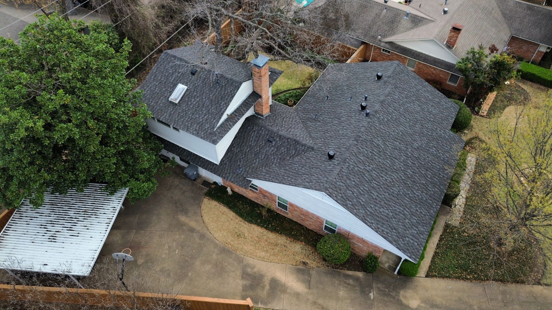 An aerial view of a house with a new roof.