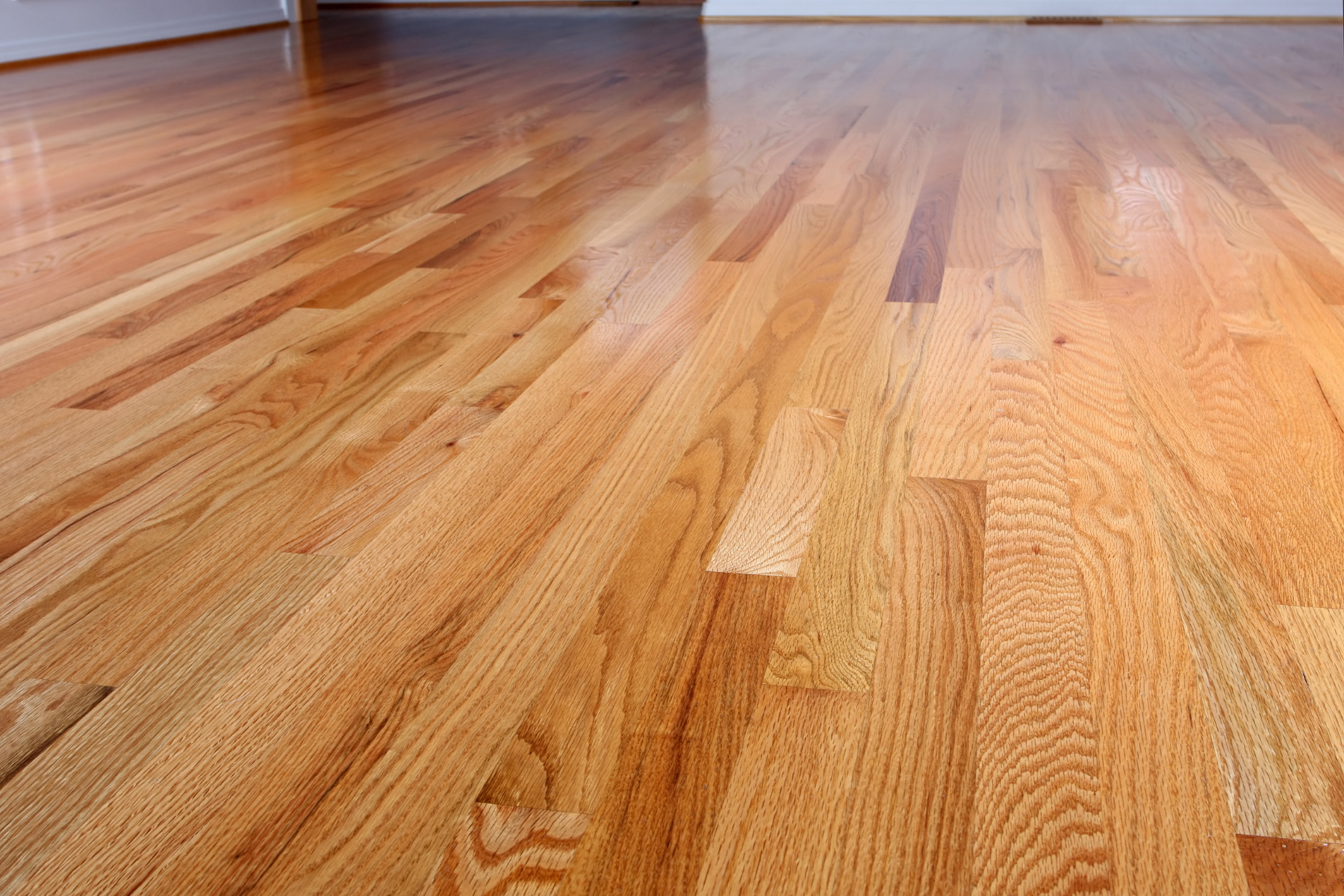 A close up of a wooden floor in an empty room.