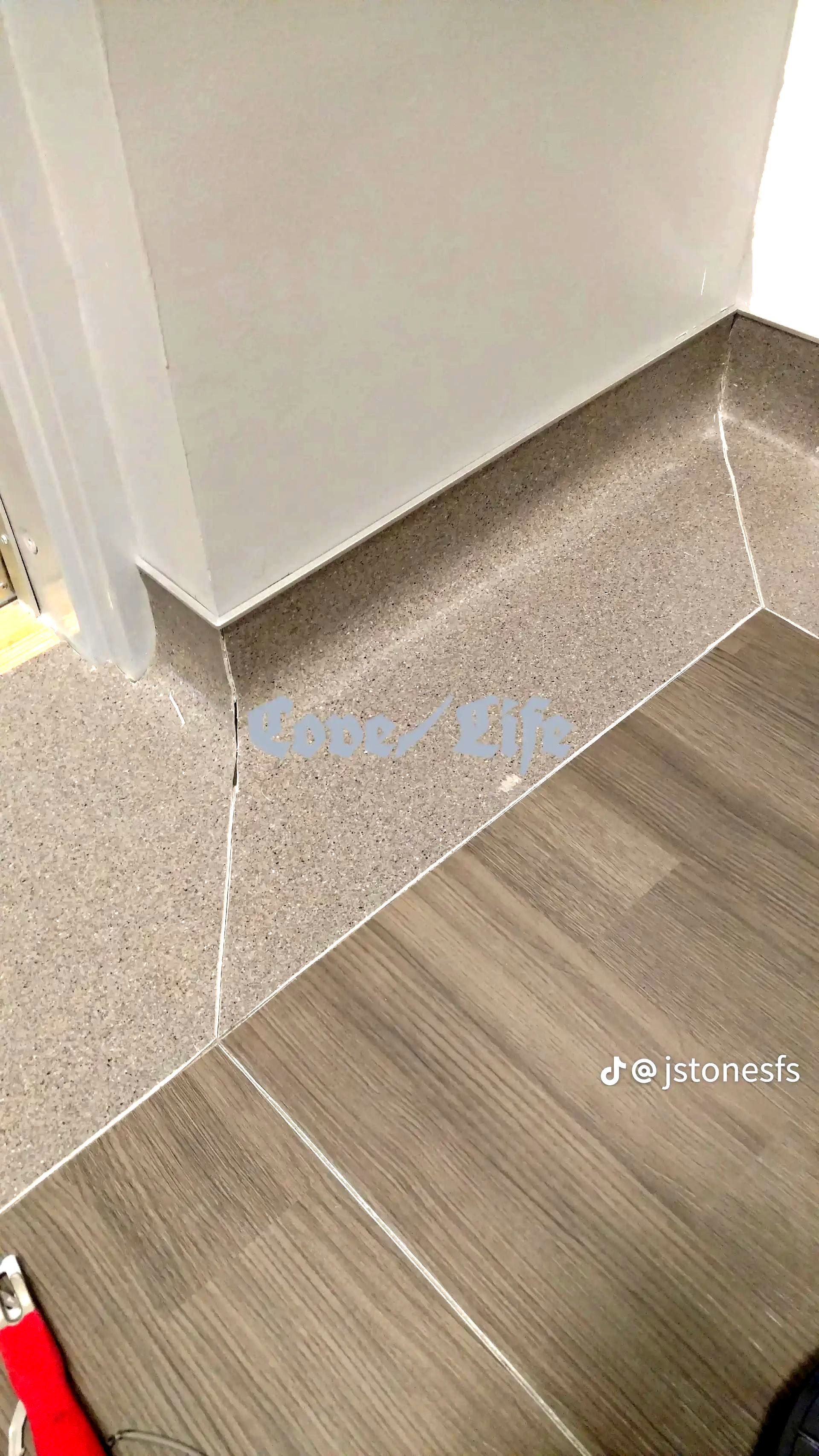 A bathroom with a wooden floor and a granite counter top.