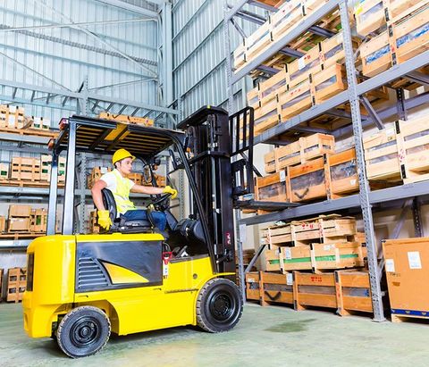 Driver Lifting Pallet In Storage — Piscataway, NJ — Central Forklift Inc.