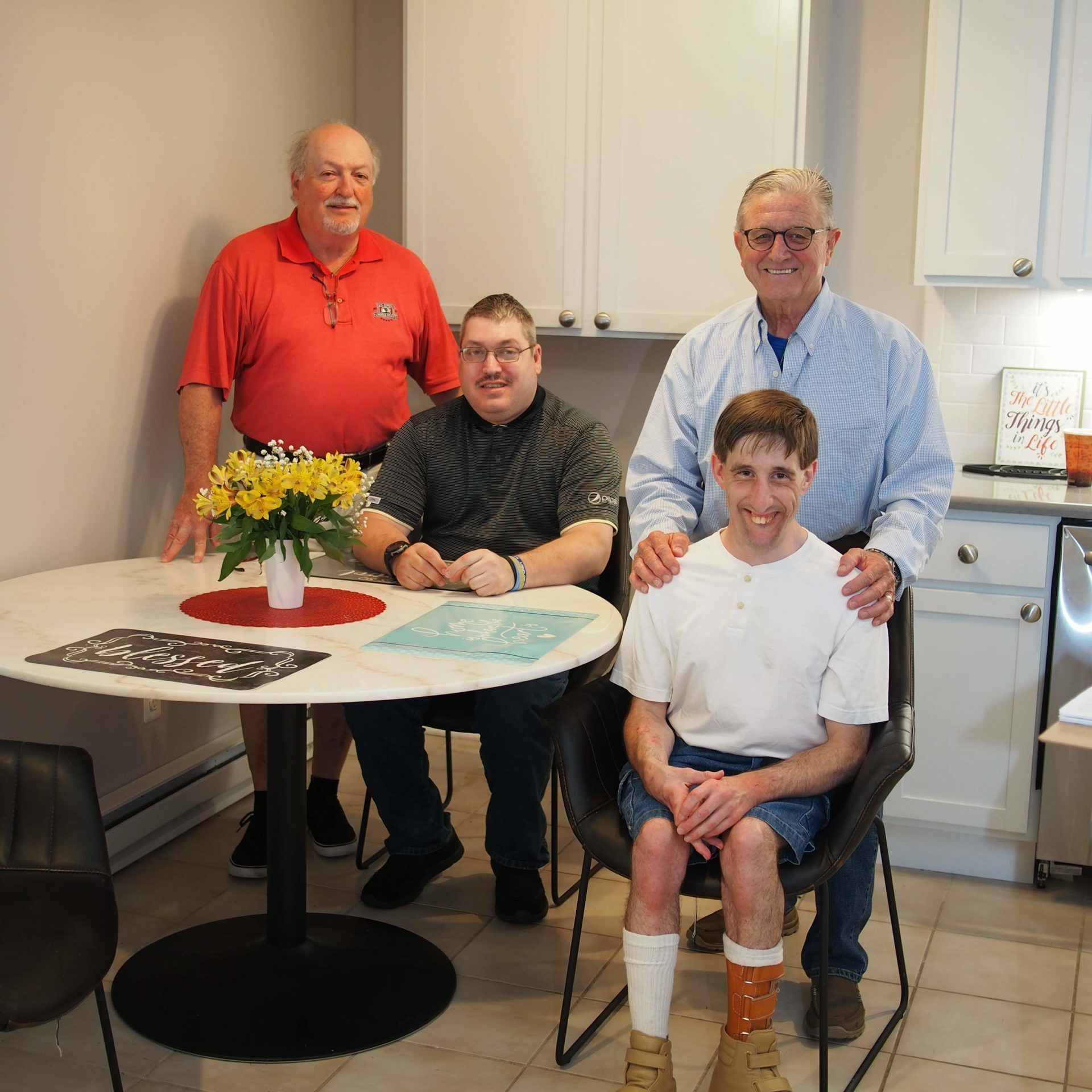 A group of men are posing for a picture in a kitchen