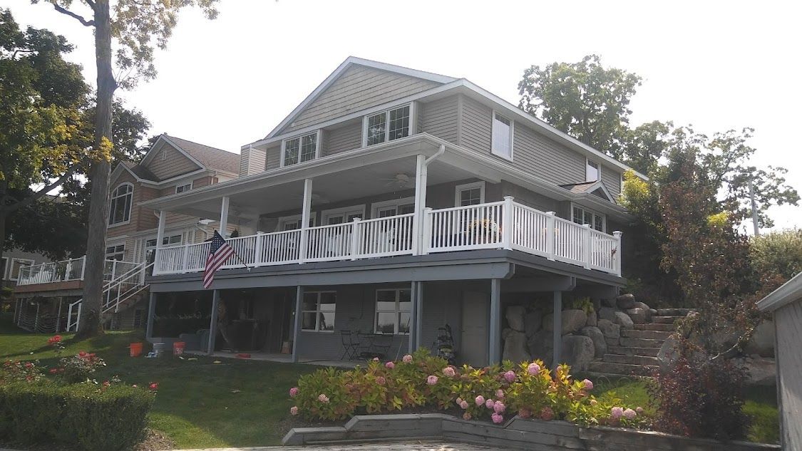 A large house with a lot of windows and a large deck.